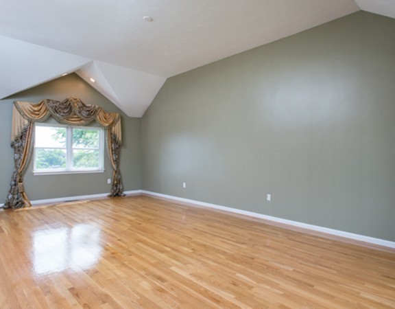 129 Raffaele Drive Waltham, MA 02452 - Photo 16 of 20 an empty room with wooden floor and windows