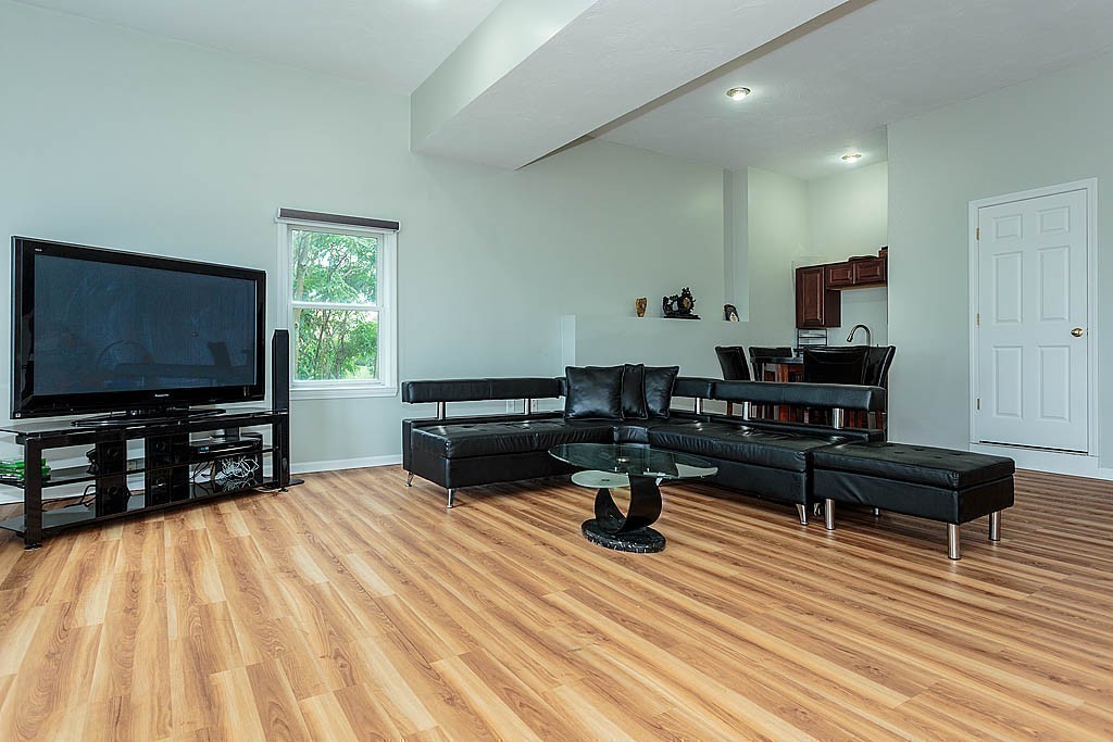 129 Raffaele Drive Waltham, MA 02452 - Photo 18 of 20 a living room with furniture and a flat screen tv