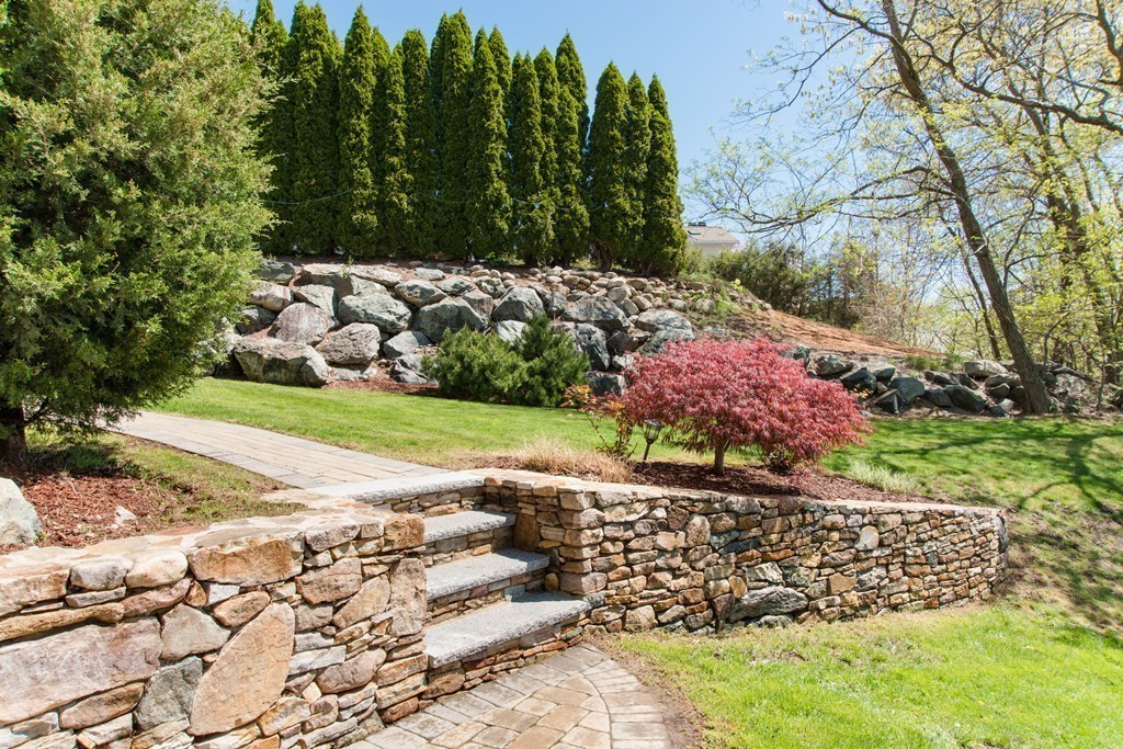 129 Raffaele Drive Waltham, MA 02452 - Photo 4 of 20 a view of a yard with plants and large trees