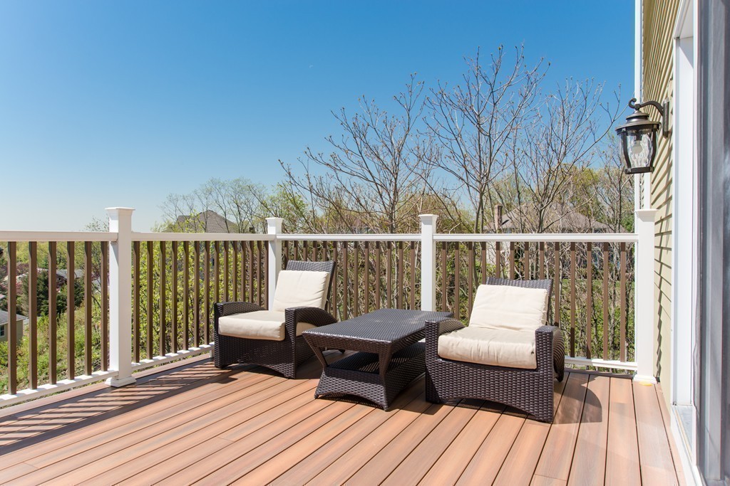129 Raffaele Drive Waltham, MA 02452 - Photo 8 of 20 a balcony with wooden floor and fence