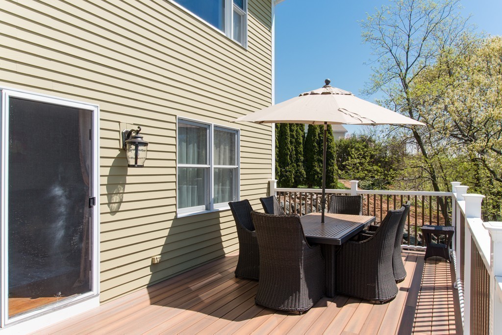 129 Raffaele Drive Waltham, MA 02452 - Photo 9 of 20 a view of a patio with a table and chairs
