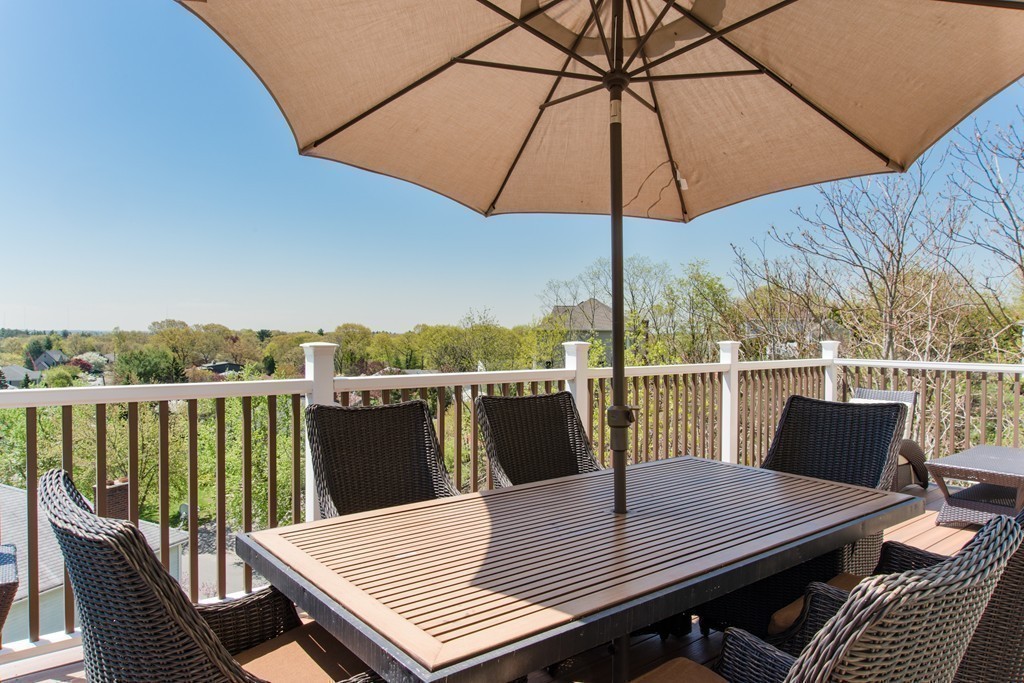 129 Raffaele Drive Waltham, MA 02452 - Photo 10 of 20 a view of balcony with furniture and umbrella
