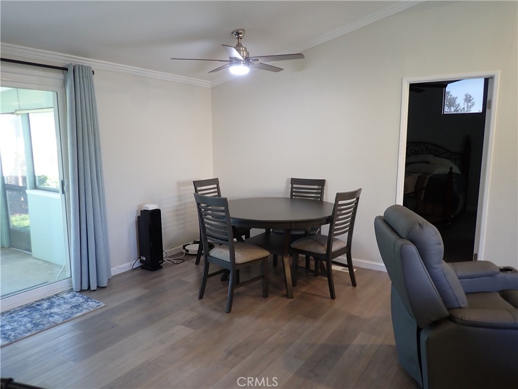 27250 Murrieta Road, Unit 386 Menifee, CA 92586 - Photo 6 of 32 a view of a dining room with furniture and a chandelier