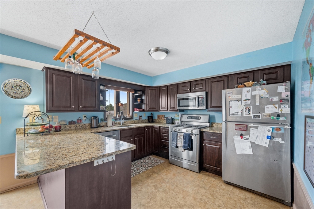 84 Century Way, Unit 84 Gardner, MA 01440 - Photo 11 of 42 a kitchen that has a lot of cabinets in it and stainless steel appliances