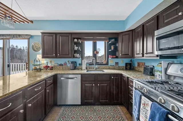 a kitchen with a sink stove top oven and cabinets