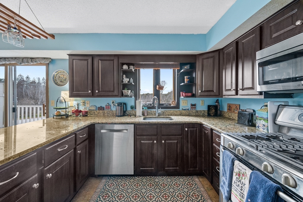 84 Century Way, Unit 84 Gardner, MA 01440 - Photo 12 of 42 a kitchen with a sink stove top oven and cabinets
