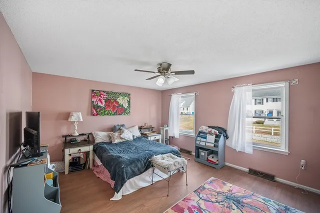 a living room with furniture a flat screen tv and a window