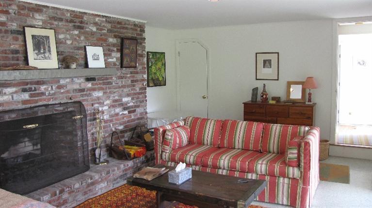 63 Old County Road Truro, MA 02666 - Photo 18 of 30 a living room with furniture a flat screen tv and a fireplace