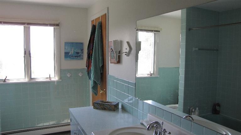 63 Old County Road Truro, MA 02666 - Photo 23 of 30 a bathroom with a sink a toilet and mirror