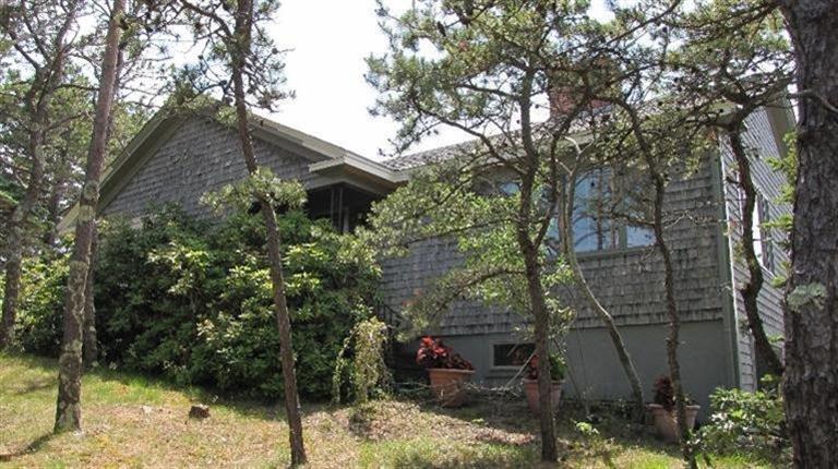 63 Old County Road Truro, MA 02666 - Photo 3 of 30 a backyard of a house with lots of trees
