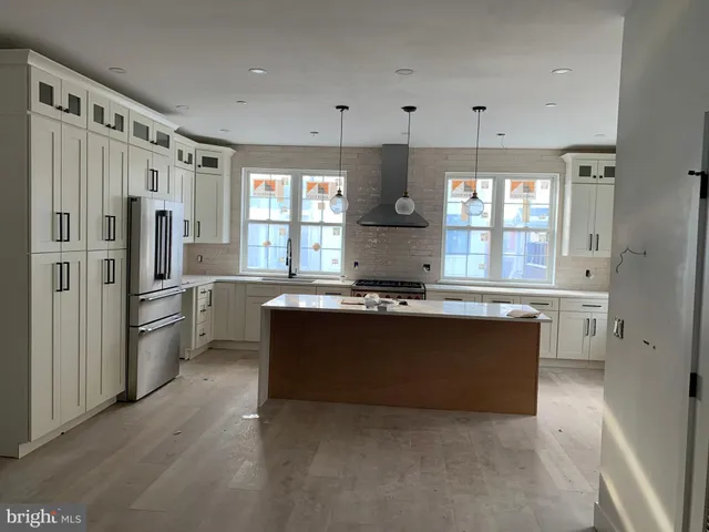 a kitchen with a sink stove and refrigerator
