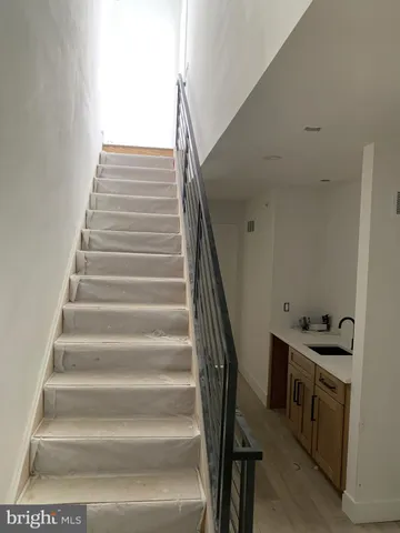 a spacious bathroom with a double vanity sink a mirror and a toilet