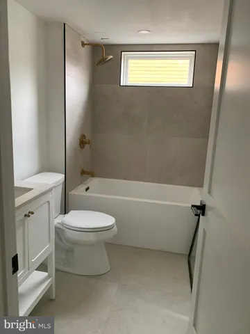 a view of a livingroom with furniture and windows