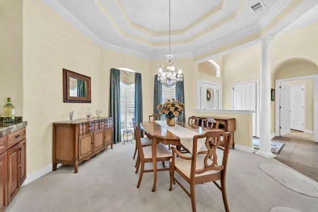 a view of a dining room with furniture and chandelier