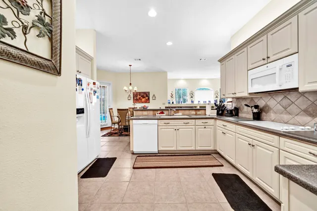a kitchen with stainless steel appliances kitchen island granite countertop a sink and cabinets