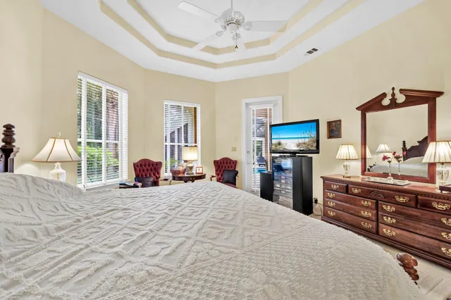 a bedroom with a large bed and a flat tv screen