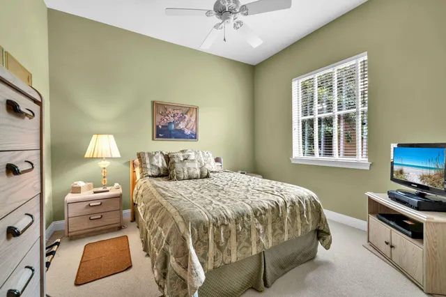 a bedroom with a bed and a tv on the dresser
