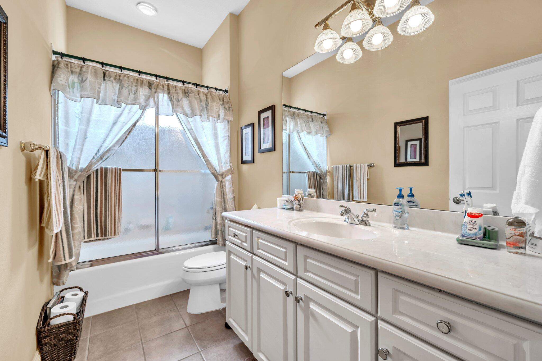 423 Maritime Court Destin, FL 32541 - Photo 30 of 39 a bathroom with a sink a toilet and a mirror