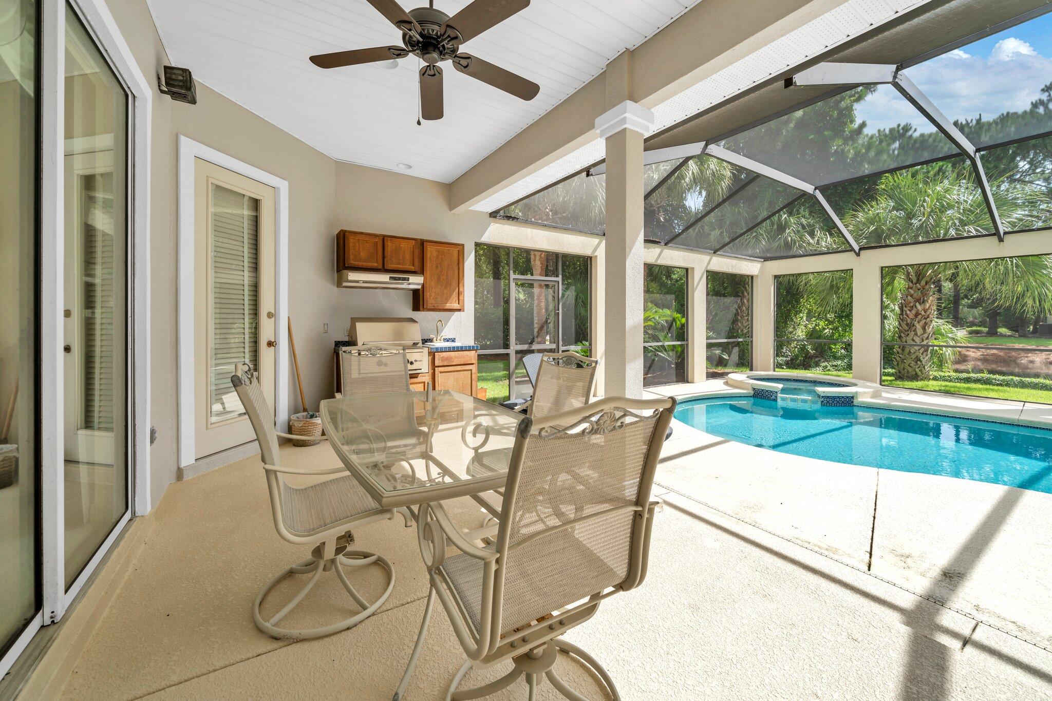 423 Maritime Court Destin, FL 32541 - Photo 3 of 39 a view of a dining room with furniture wooden floor and a chandelier