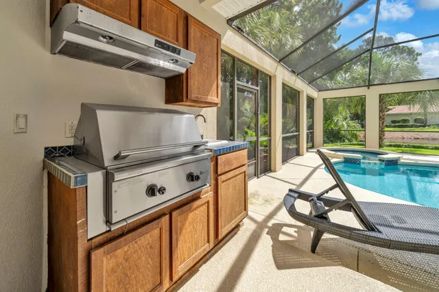 a view of a kitchen with a stove and a wooden floor