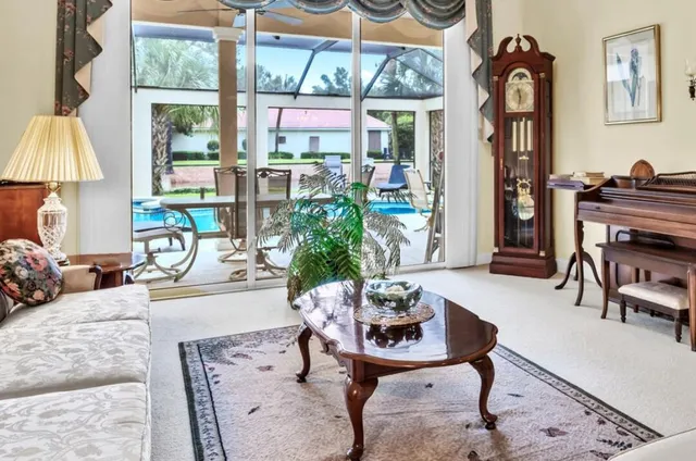 a living room with furniture a table and a chandelier