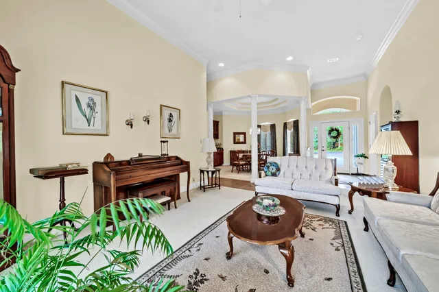 a living room with furniture and a piano