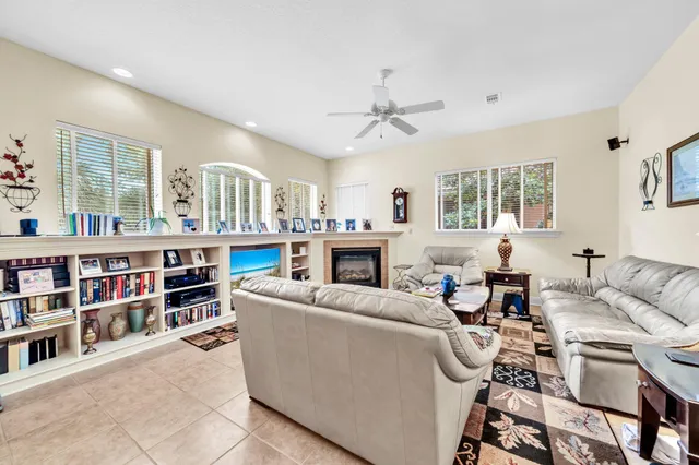 a living room with furniture a bookshelf and a fireplace