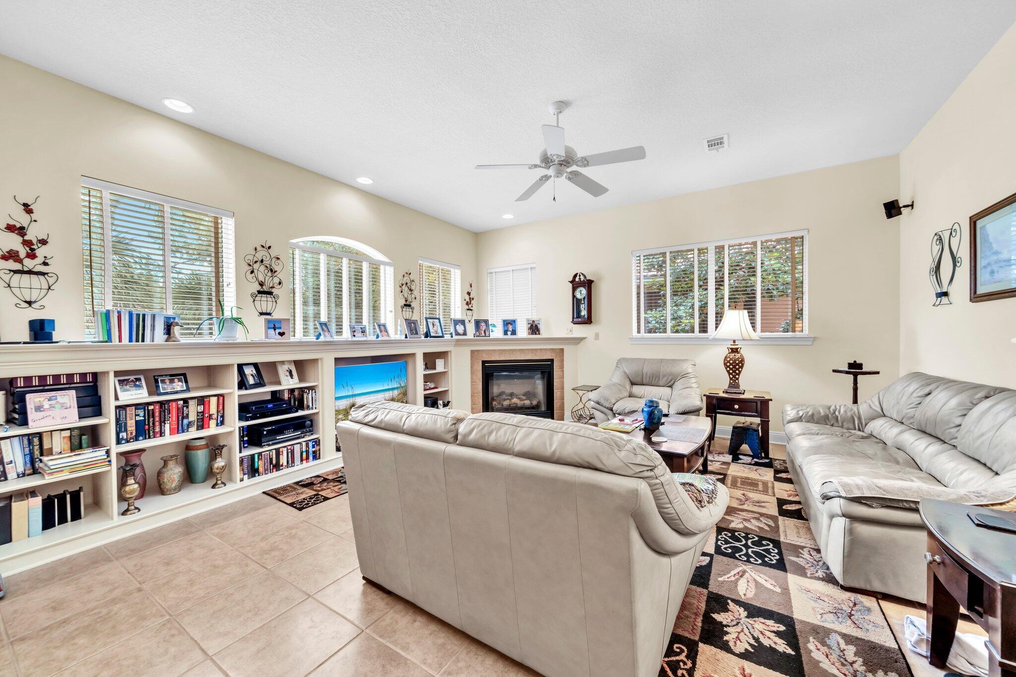 423 Maritime Court Destin, FL 32541 - Photo 10 of 39 a living room with furniture a bookshelf and a fireplace