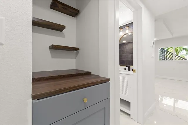 an empty room with closet and a chandelier fan