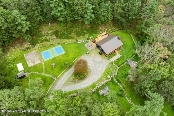 a living room with furniture large window and flat screen tv