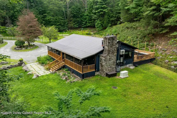 a backyard of a house with yard and outdoor seating