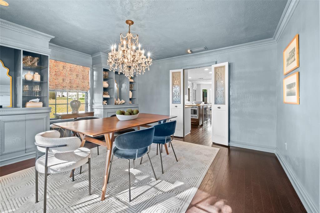 9315 Moss Cir Drive Dallas, TX 75243 - Photo 15 of 36 a view of a dining room with furniture wooden floor and chandelier