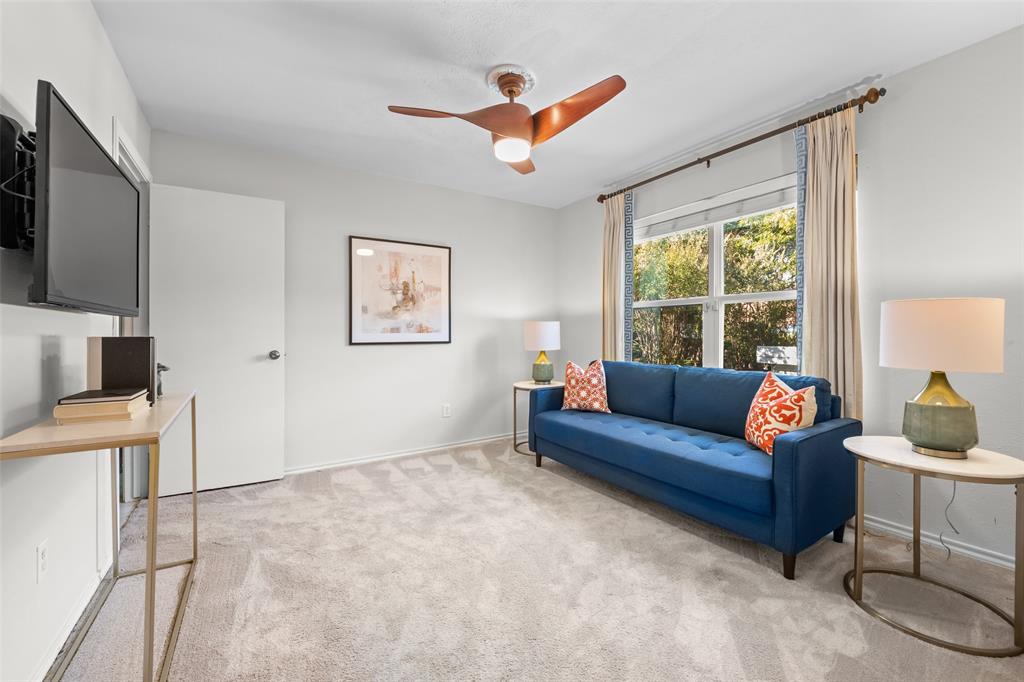 9315 Moss Cir Drive Dallas, TX 75243 - Photo 19 of 36 a living room with furniture a flat screen tv and a window