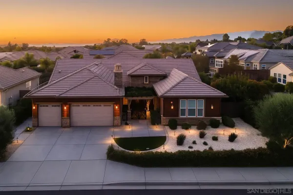 a front view of house with yard and mountain view in back