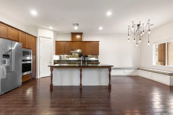 a kitchen with kitchen island white cabinets and stainless steel appliances