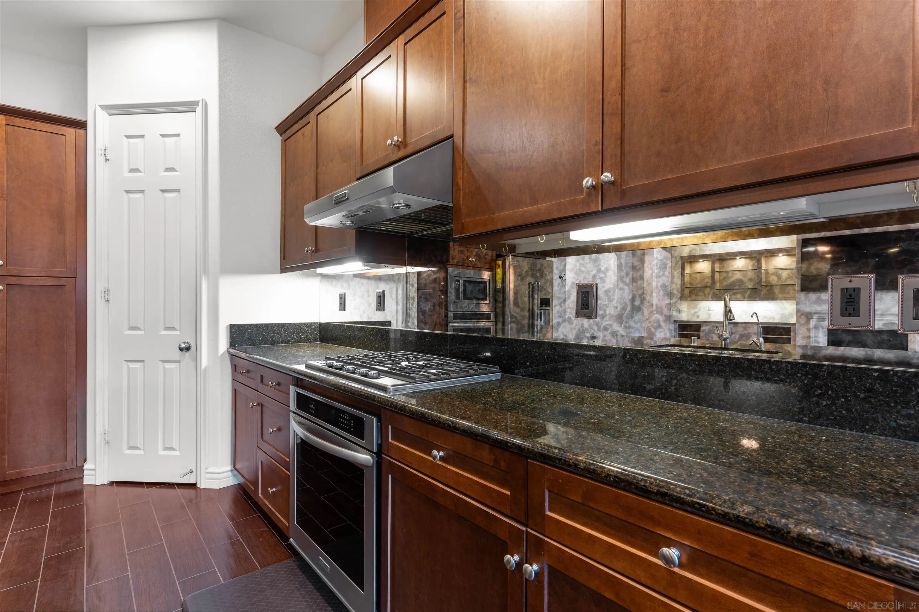 2067 James Gaynor Street Fallbrook, CA 92028 - Photo 14 of 33 a kitchen with granite countertop a stove and a wooden floors