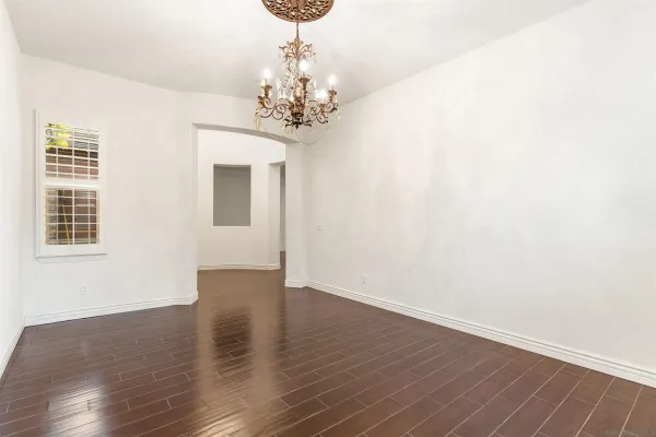 a view of a livingroom with a chandelier wooden floor and chandelier