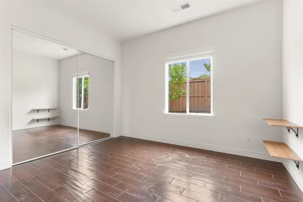 wooden floor in an empty room with a window