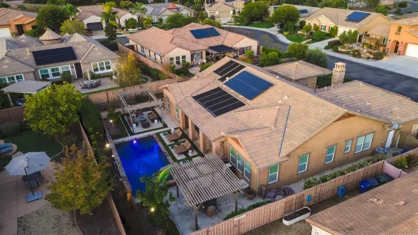an aerial view of residential houses with outdoor space