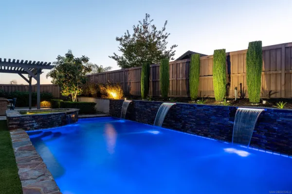 a swimming pool with outdoor seating and city view