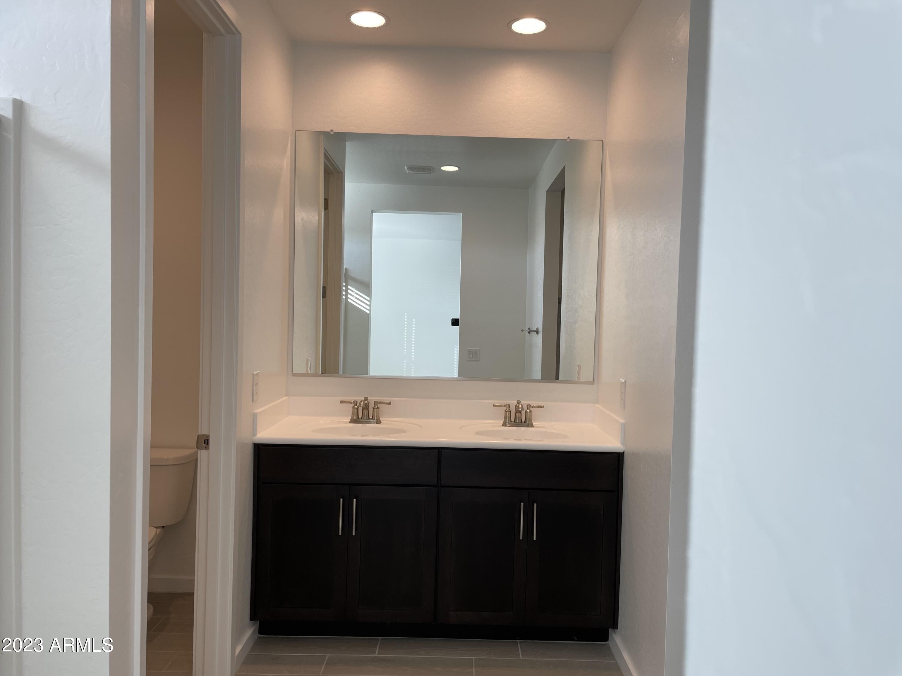 17401 West Red Fox Road Surprise, AZ 85387 - Photo 12 of 41 a bathroom with a double vanity sink and mirror