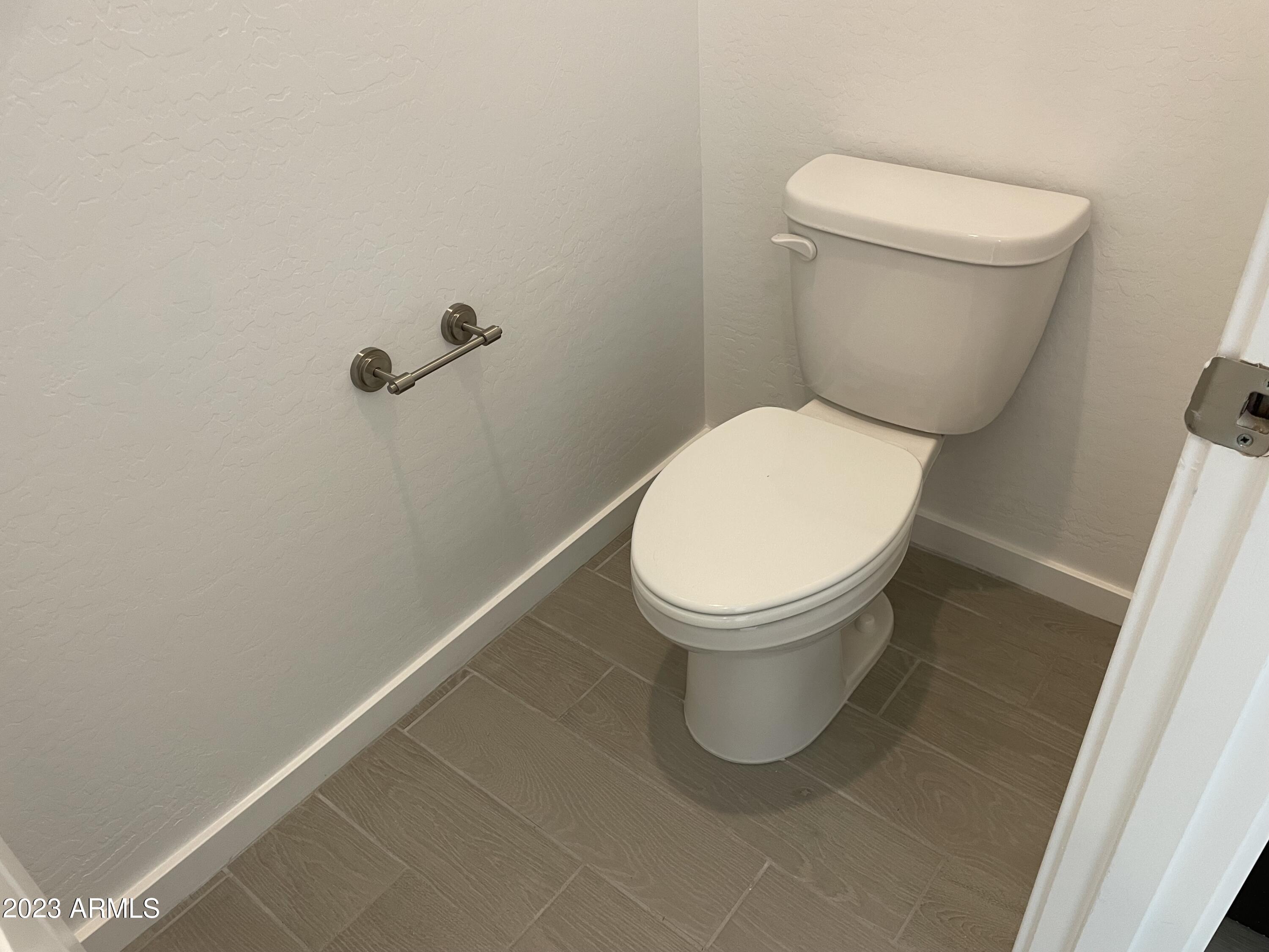 17401 West Red Fox Road Surprise, AZ 85387 - Photo 14 of 41 a white toilet sitting next to a white sink