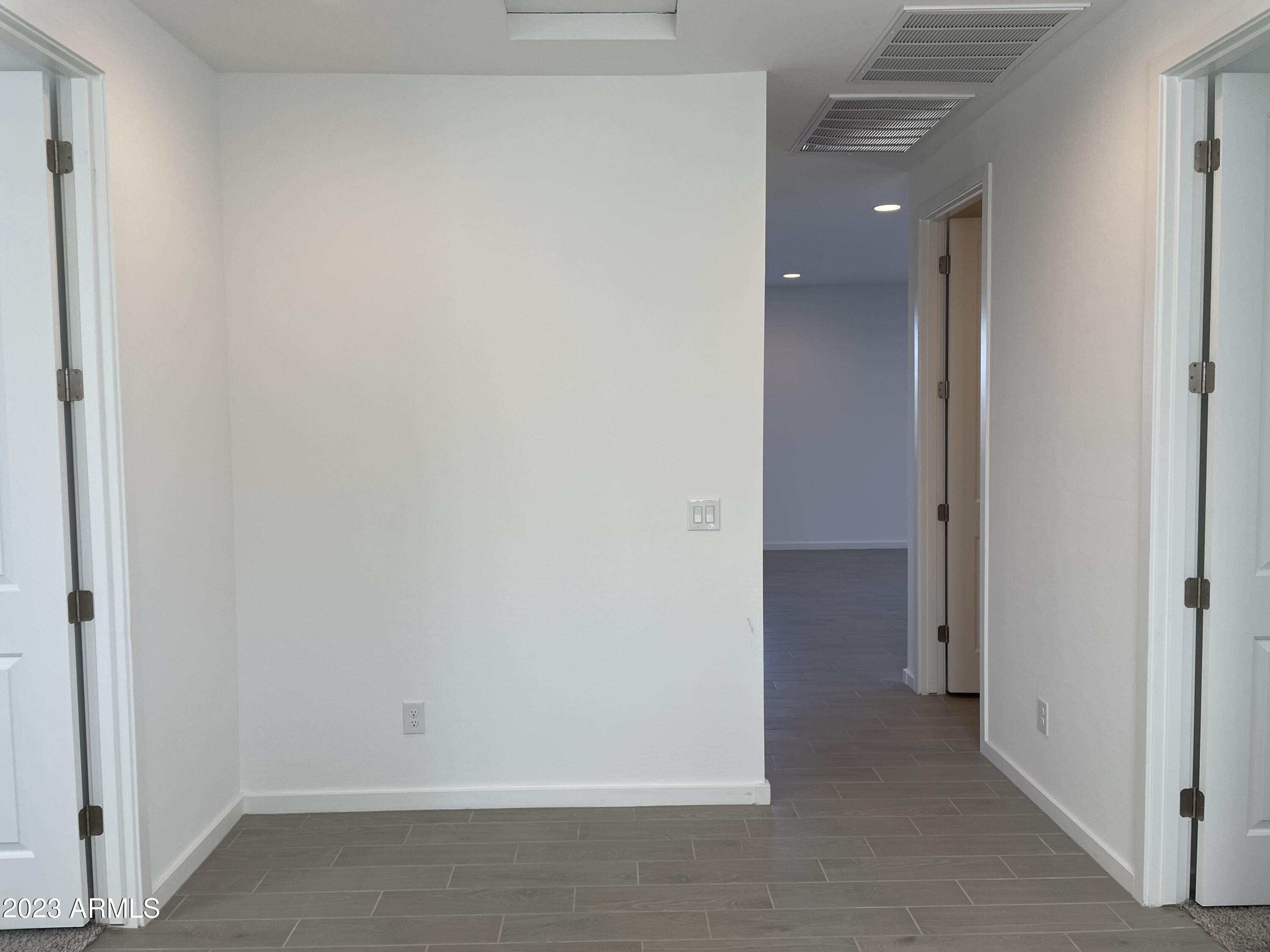 17401 West Red Fox Road Surprise, AZ 85387 - Photo 18 of 41 wooden floor in an empty room