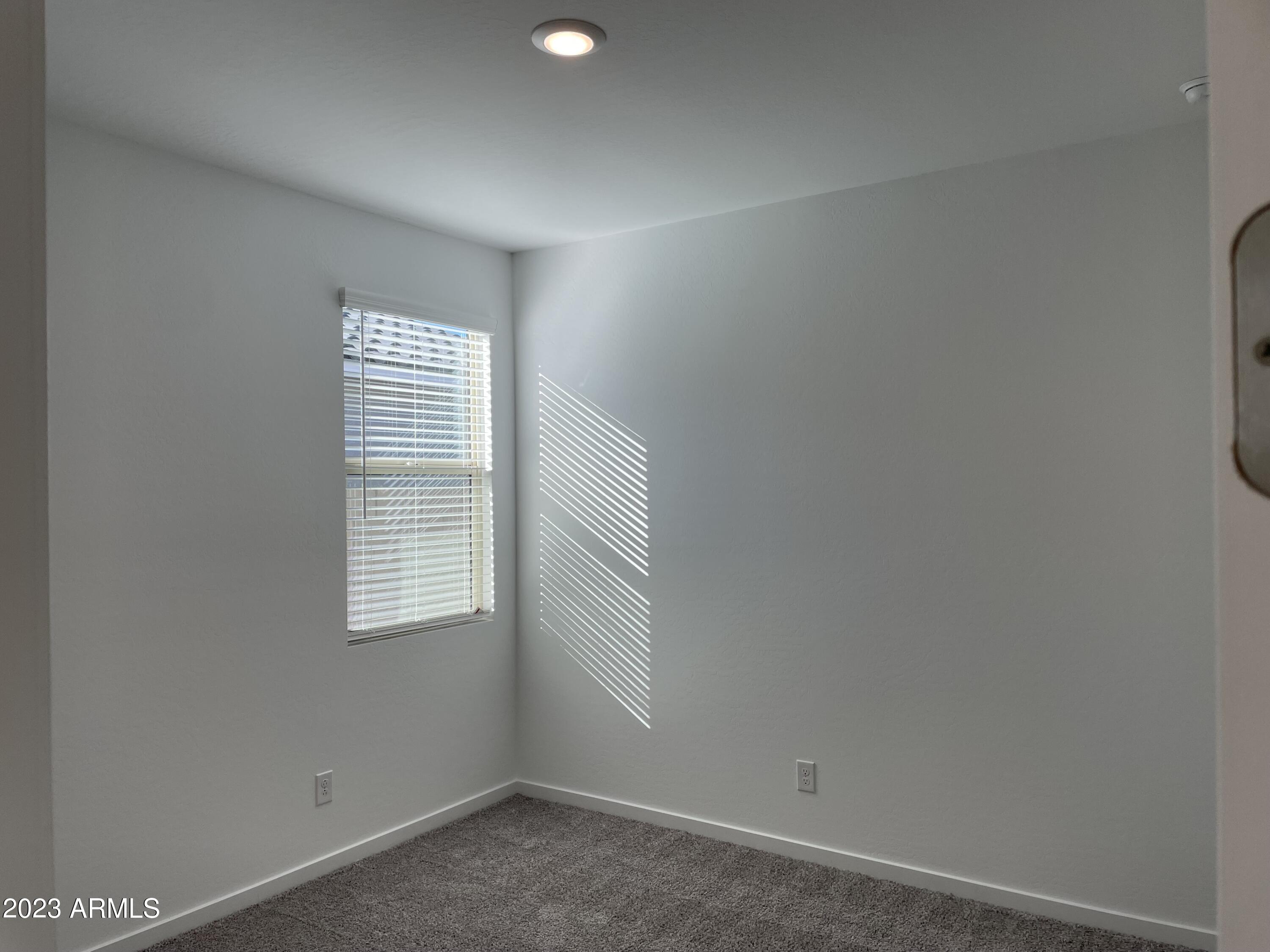 17401 West Red Fox Road Surprise, AZ 85387 - Photo 21 of 41 a view of an empty room with a window