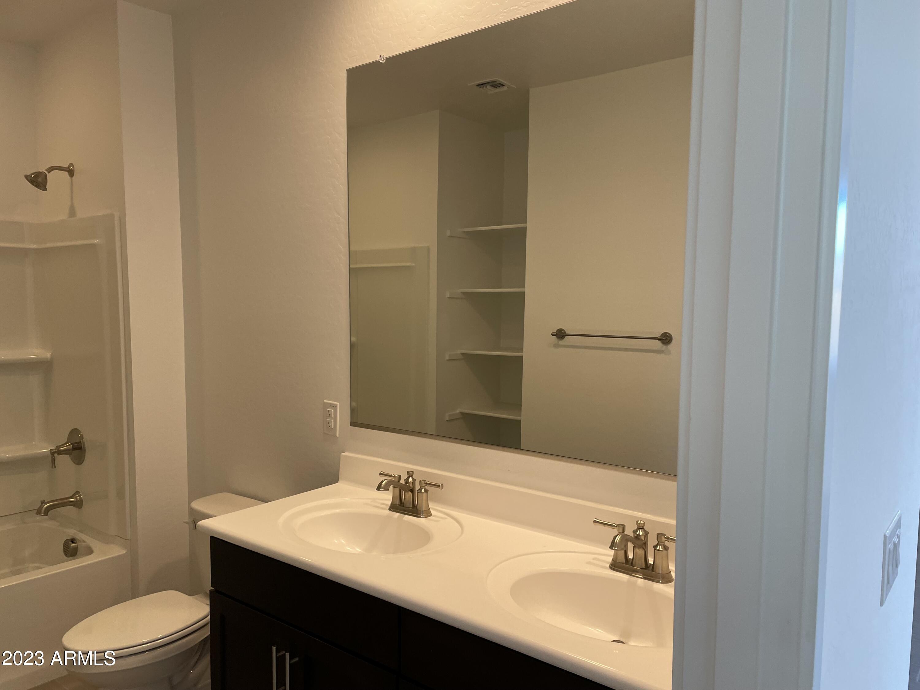 17401 West Red Fox Road Surprise, AZ 85387 - Photo 23 of 41 a bathroom with a sink a toilet and shower