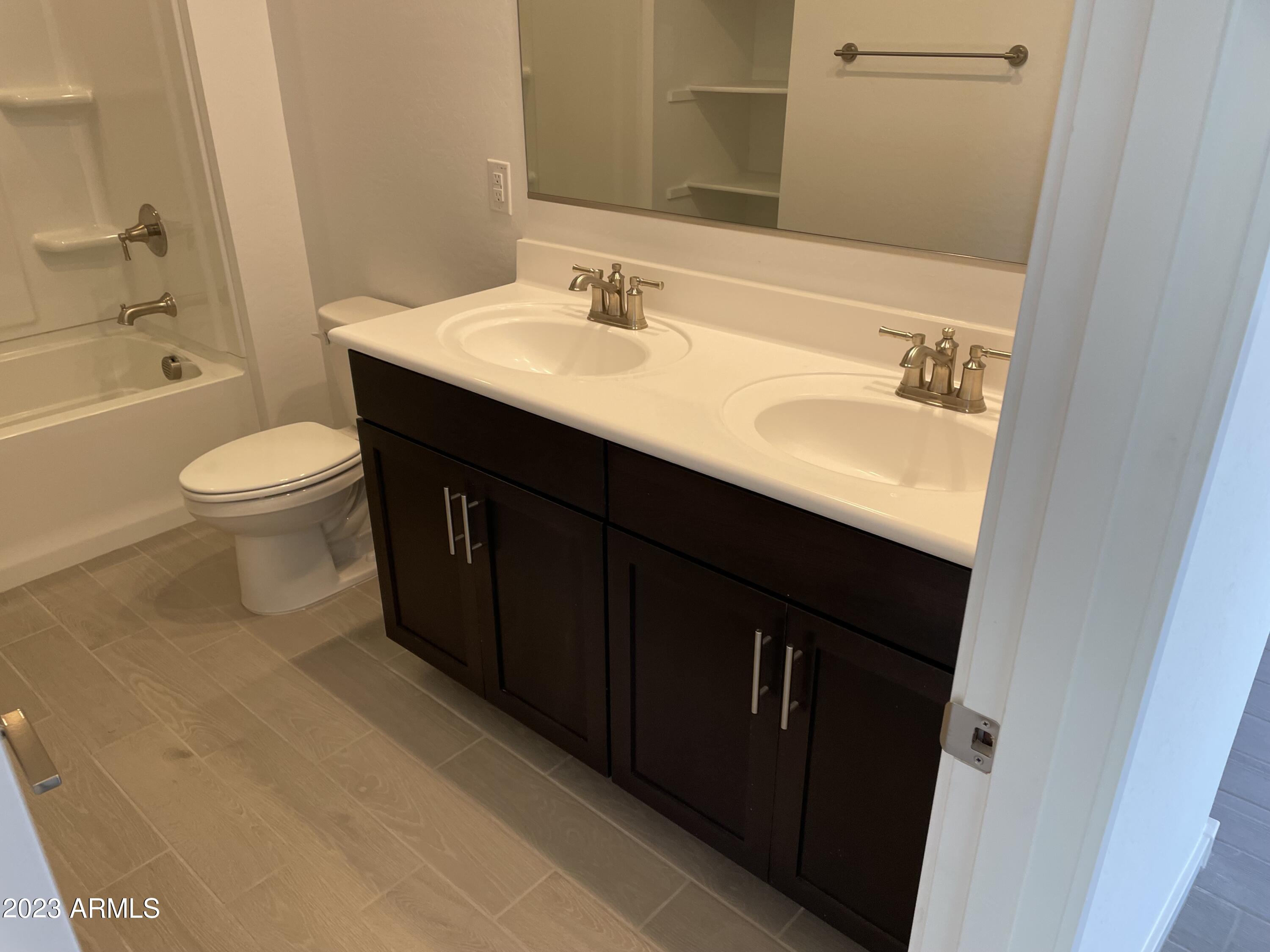 17401 West Red Fox Road Surprise, AZ 85387 - Photo 24 of 41 a bathroom with a sink a toilet and shower