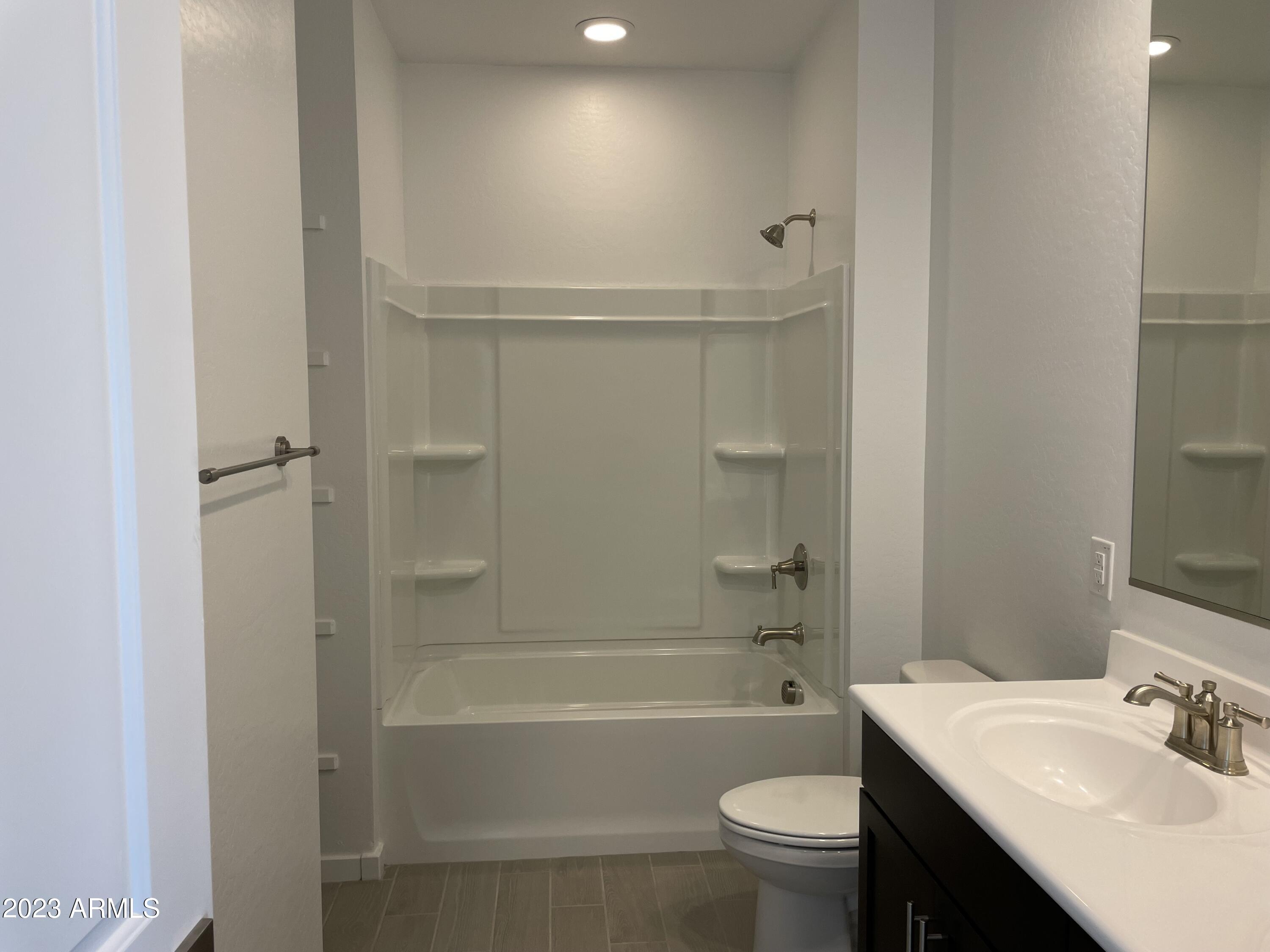 17401 West Red Fox Road Surprise, AZ 85387 - Photo 25 of 41 a bathroom with a sink a toilet and shower