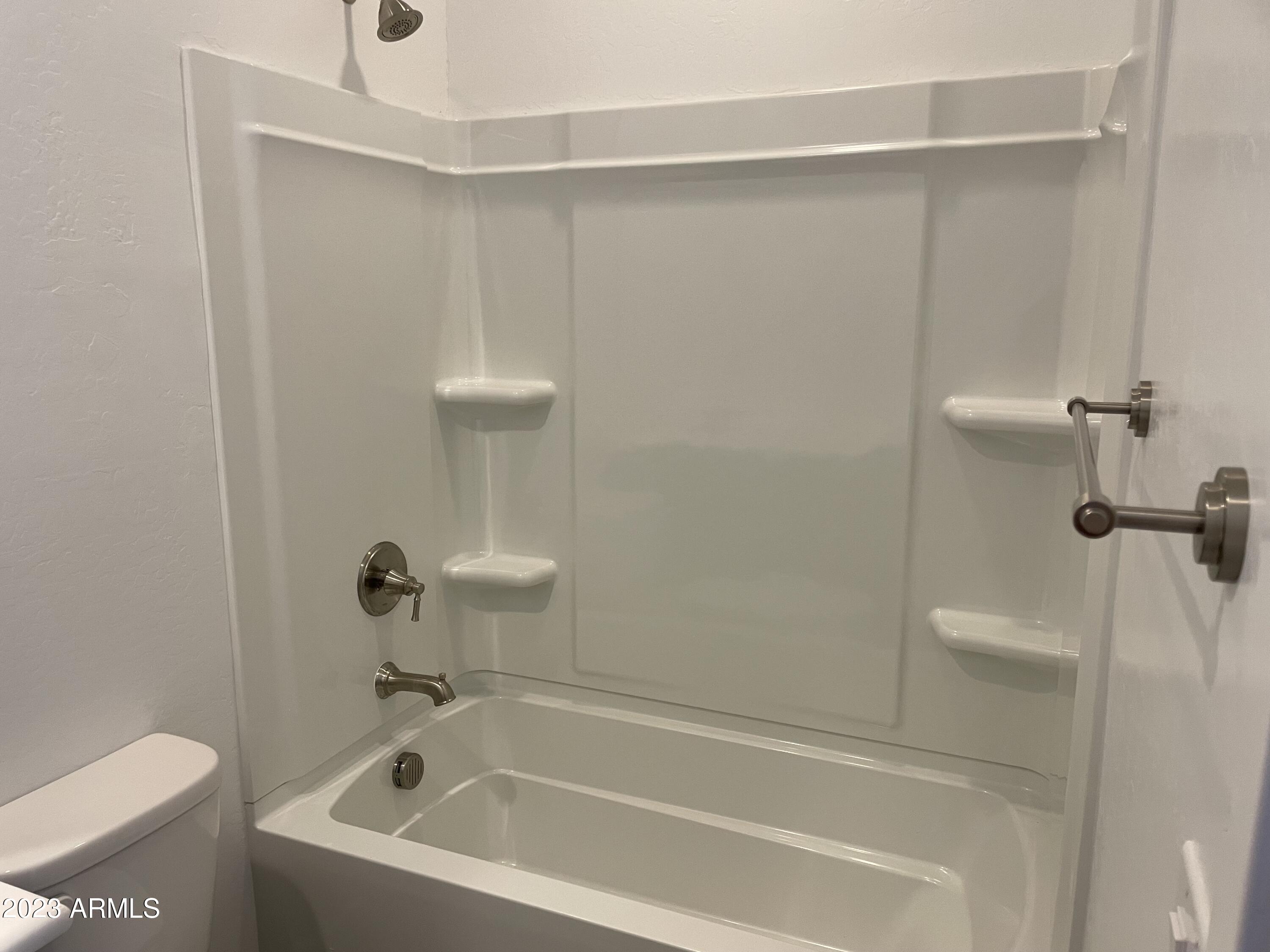 17401 West Red Fox Road Surprise, AZ 85387 - Photo 30 of 41 a white bath tub sitting next to a toilet