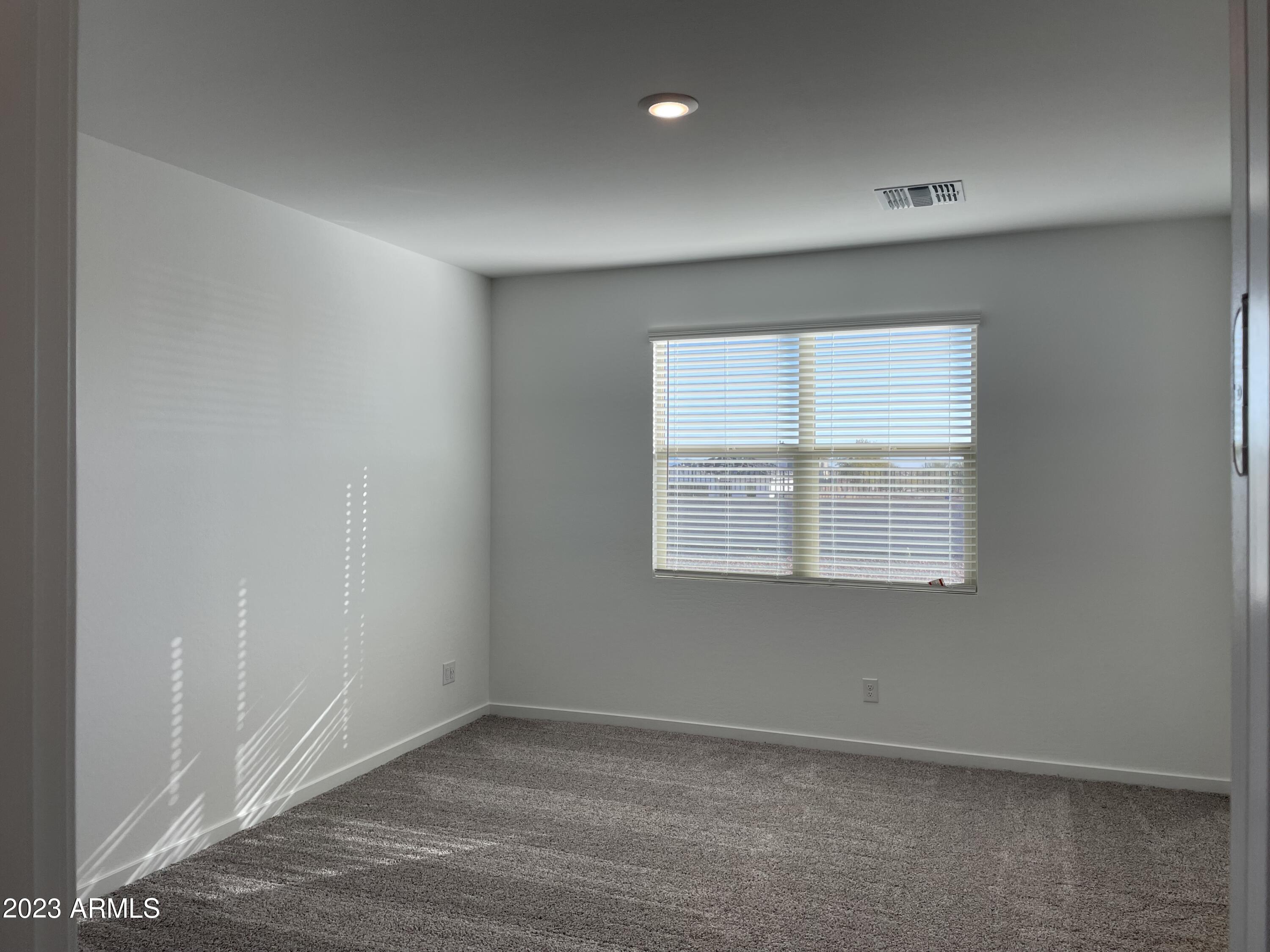 17401 West Red Fox Road Surprise, AZ 85387 - Photo 10 of 41 an empty room with a window