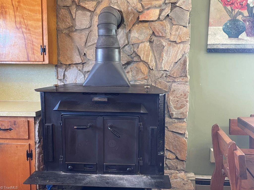 482 Grange Road Elkin, NC 28621 - Photo 5 of 29 Woodstove with rock wall